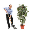 Person holding a shovel and decoration plant