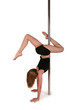 Photo: Young woman exercising pole dance fitness Young woman exercising pole dance fitness