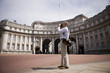 A man standing by Admiralty Arch, taking a photograph