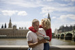 Photo: A middle-aged couple in front of the Houses of Parliament A middle-aged couple in front of the Houses of Parliament