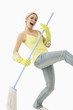 Woman using mop as guitar