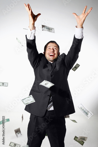 Photo: Businessman throwing money in the air Businessman throwing money in the air