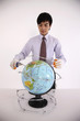 Man coiling barbed wire around globe