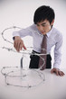 Man taking plastic water bottle from inside coiled barbed wire
