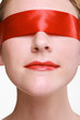 Woman being blindfolded with red ribbon