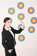 Businesswoman holding darts