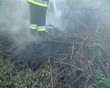 Uniformed firefighter with the hose in the hands fighting fire. Uniformed firefighter with the hose in the hands fighting fire.