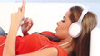 Young girl on couch listen to the music with headphones