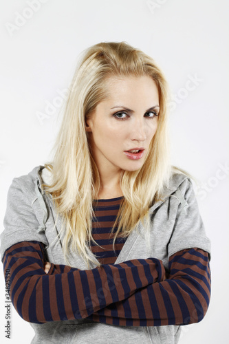 Photo: Woman staring while crossing her arms Woman staring while crossing her arms