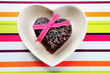 Heart-shaped chocolate fudge cake with pink ribbon