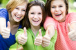 Three girls with thumbs up Three girls with thumbs up
