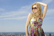 beautiful girl in sunglasses on background blue sky