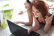 Two pretty girls shopping over internet Пометка редактора: