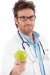 Handsome doctor holding green apple