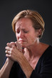 Middle aged woman praying