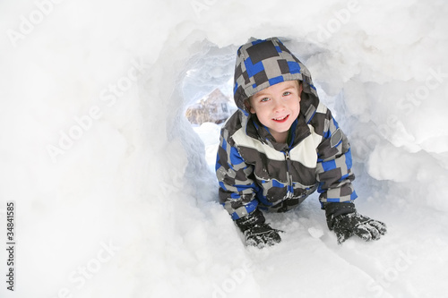 Photo: Young boy playing in the snow Young boy playing in the snow