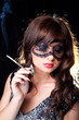 Foto: Smoking lady with lacy mask on black Smoking lady with lacy mask on black