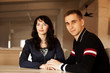 Photo: young couple in love sitting together at home young couple in love sitting together at home
