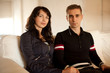 Photo: young couple in love sitting together at home young couple in love sitting together at home