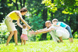 happy young couple with their children have fun at park happy young couple with their children have fun at park
