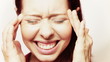 Woman with headache massaging her temples
