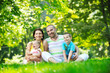 happy young couple with their children have fun at park
