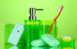 bathroom accessories, soap and towel on green background