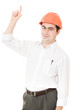 Businessman in helmet pointing up.