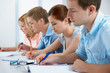 group of students studying together in a classroom