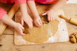 little girls cutting gingerbread christmas cookies, hands only little girls cutting gingerbread christmas cookies, hands only