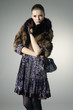 Photo: High fashion model in autumn/winter clothes with handbag posing High fashion model in autumn/winter clothes with handbag posing