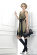 fashion model holding little purse posing in the studio