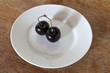 Two cherries on a plate
