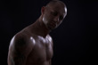 Young muscle bold male model in studio