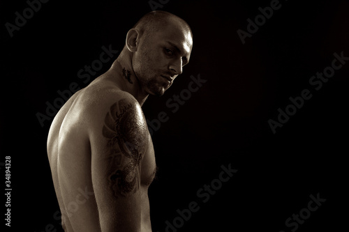 Photo: Young muscle bold male model in studio Young muscle bold male model in studio