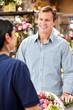 Man serving customer in florist
