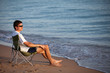 young man resting on the beach
