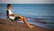young man resting in the chaise longue on the beach