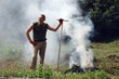 Man burn out dry grass in the garden.Ukraine