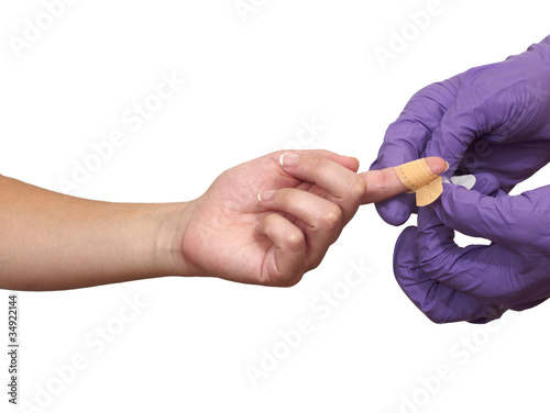 Photo: Nurse applying Adhesive Bandage Nurse applying Adhesive Bandage