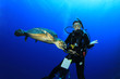 Photo: Female Scuba Diver encounters curious Hawksbill Sea Turtle Female Scuba Diver encounters curious Hawksbill Sea Turtle