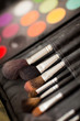 cosmetic brushes. multicolored eye shadows with cosmetics brush