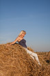 Photo: The beautiful girl jumps off from a haystack The beautiful girl jumps off from a haystack