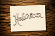 Hand writing on cream paper with ruin wood background