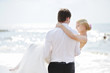 Beach wedding: bride and groom by the sea