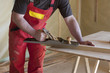 Photo: carpenter works on a wood house with a planer carpenter works on a wood house with a planer