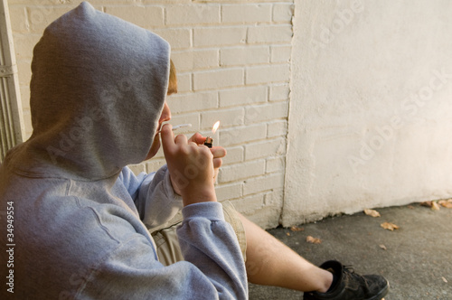 Photo: teen boy lighting a joint teen boy lighting a joint