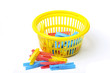 Yellow basket with clothes pegs