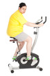 overweight woman on stationary fitness bicycle, series