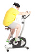 Foto: overweight woman on stationary fitness bicycle, series overweight woman on stationary fitness bicycle, series
